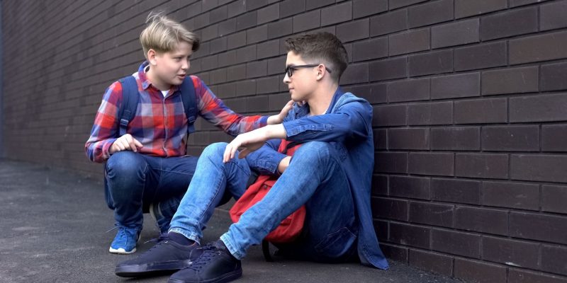 boy showing fruit of the spirit kindness to another boy